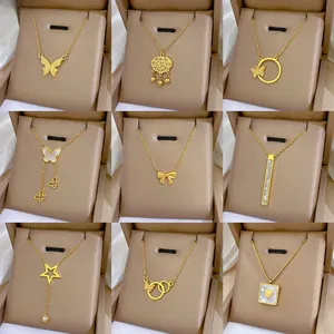 Macro shot of nine golden titanium steel choker necklaces with butterfly and heart charms