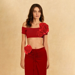 Detail of red two-piece set featuring 3D fabric rose accents and high-waist maxi skirt