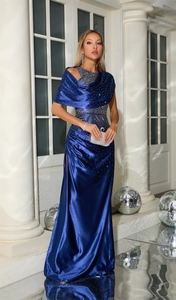 Close-up of starry blue evening gown with rhinestones, satin fabric, and high side slit