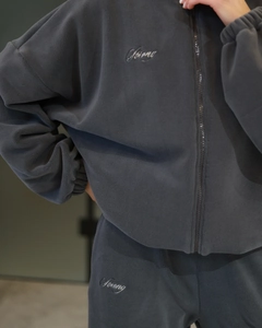 Detail of dark grey polar fleece tracksuit with high-quality white Strong letter embroidery
