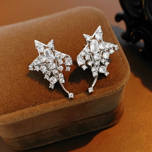 Detail of silver star tassel earrings featuring sparkling white cubic zirconia on velvet
