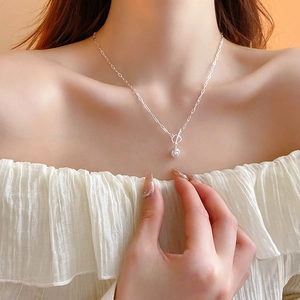 Elegant silver OT buckle chain necklace with a single round pearl pendant on a model