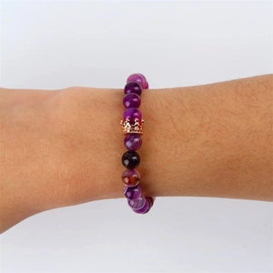 Purple agate beaded bracelet with rose gold crown charm on model wrist shot