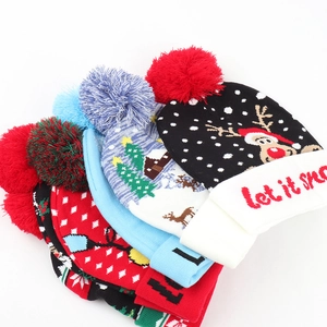 Winter pompom knit beanie with Christmas reindeer and snowflake jacquard patterns