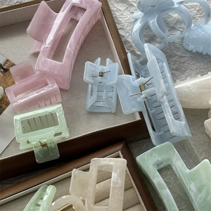 Detail of marble pattern hair claw clips in pastel colors with metal spring structure