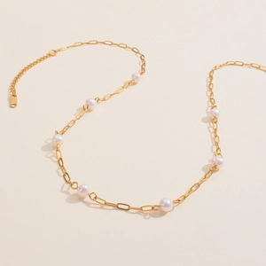 Detail showing 18K gold stainless steel chain with round freshwater pearls in S-curve