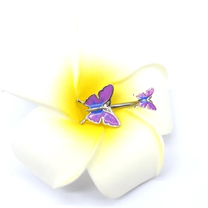 Macro detail of purple and blue gradient butterfly navel ring resting on a white flower
