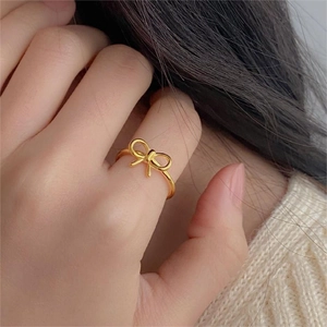 Elegant 925 silver golden bow ring shown on model for a refined minimalist aesthetic