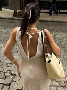 Elegante abito con scollo a V e schiena scoperta con lacci e gonna a contrasto in città