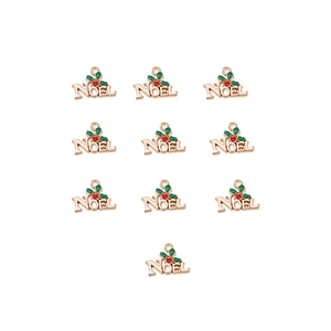 Detail of 10 gold Noel alloy charms with green holly leaves and red berries for DIY crafts