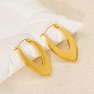 Detailed view of polished 18k gold-plated V-shaped hoop earrings on a display