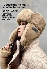 Detail of khaki earflap hat showing the thick plush lining and adjustable chin buckle
