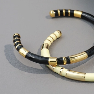 Bamboo style enamel open cuff bracelets in black and cream gold for a luxury look