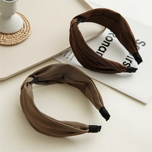 Detailed texture of silk-satin twisted headbands in brown and cocoa earth tones