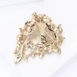 Detailed back view of gold rhinestone heart brooch featuring secure pin buckle mechanism