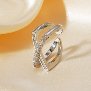 Elegant silver-toned crisscross open ring featuring micro-pave cubic zirconia on silk