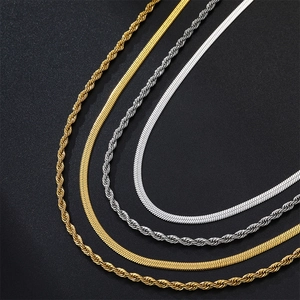 Detailed close-up of 18k gold and silver stainless steel rope and herringbone chains