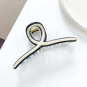 Large beige hair claw clip with black trim on white background for thick hair