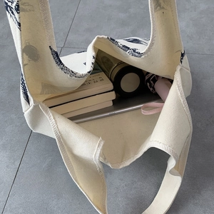 Spacious canvas tote showing large capacity for books, tablet, and daily essentials