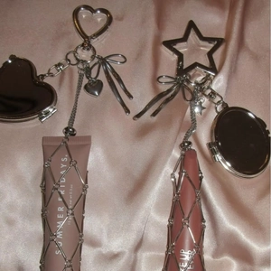 Silver metal mesh lipstick holder with star carabiner and mini heart mirror charms
