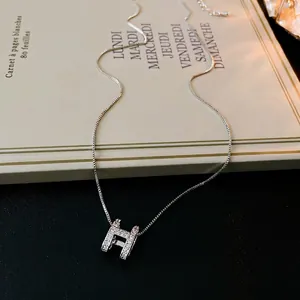 Elegant silver H-shaped necklace with zircon crystals on a minimalist link chain