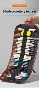 Detailed macro view of 36-piece professional pottery clay sculpting tools in a leather roll-up bag