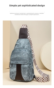 Detail of grey washed canvas bag with geometric jacquard strap and leather patch