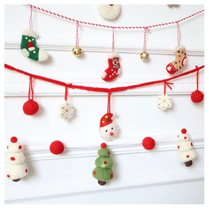 Detailed close-up of wool felt Christmas garlands featuring Santa, socks, and trees
