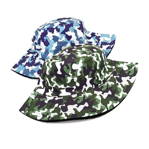 Close-up of camouflage bucket hats in blue and green patterns with twill cotton fabric
