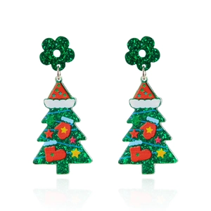 Macro shot of colorful glittery Christmas tree acrylic earrings with red hat and star details