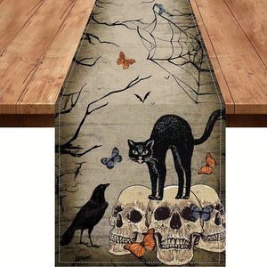 Detail of Halloween linen table runner featuring black cat on skulls with vintage motifs