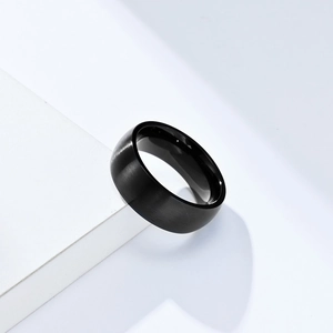 Macro shot of 8mm black matte brushed finish titanium steel ring on white stairs