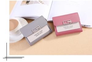 Close-up of stylish trifold PU leather wallets with elegant metal snap button and contrast color