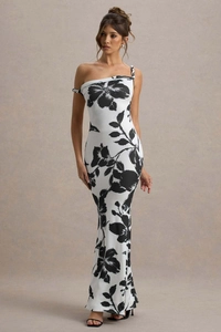 Detail of elegant black and white floral print on a slim fit one-shoulder maxi dress