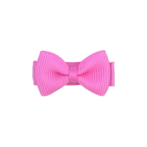 Close-up of a pink solid color candy bow hair clip for girls with ribbed texture