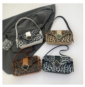 Flat lay of four leopard print underarm bags with square metal buckles in various colors