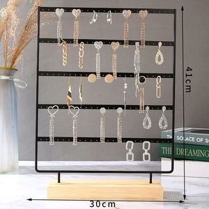 Detail view of 41x30cm metal jewelry stand with wooden base showing earring storage