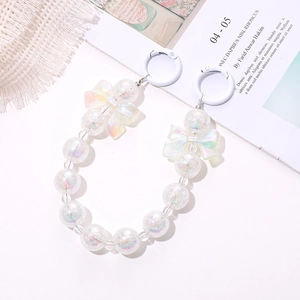 Detail of beaded mobile chain with rainbow luster pearls and white bow accents