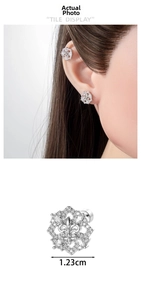 Detail of fleur-de-lis earrings with cubic zirconia, 1.23cm width jewelry close-up