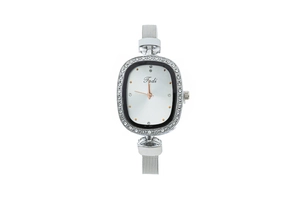 Detail of silver mesh strap watch with crystal bezel and rose gold hands on white background