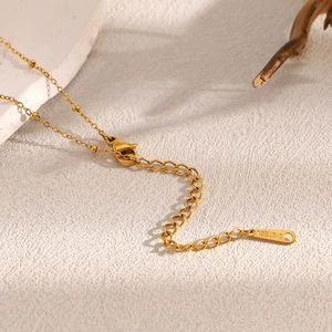 Detailed close-up of 18K gold plated stainless steel extension chain with S-STEEL tag