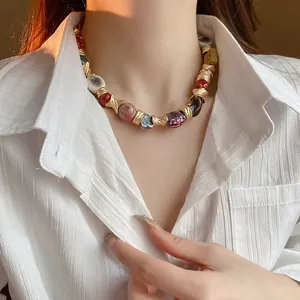 Ethnic style ceramic flower necklace with colorful beads and gold metal accents for women