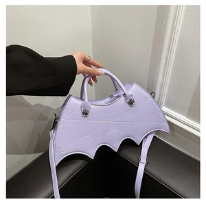 Close-up of light purple bat wing shaped bag with detailed spider web embroidery