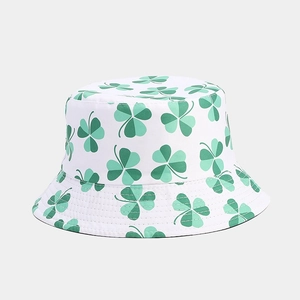 Detail view of the vibrant green shamrock pattern on a white bucket sun hat