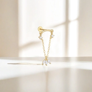 Close-up of S925 sterling silver gold earring featuring a chain fringe and clear gemstone