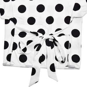 Close-up of the waist tie detail and black polka dot pattern on a white slim T-shirt