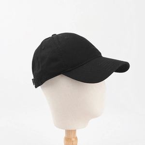 Detail of adjustable metal buckle and cotton canvas texture on black baseball cap