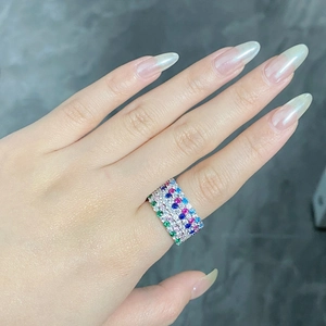 Macro shot of four stacked S925 silver rings set with vibrant multi-colored gemstones