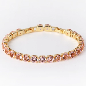 Detail of single row 6mm pink round-cut cubic zirconia in gold-plated tennis bracelet