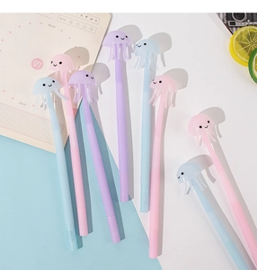 Close-up of cute silicone jellyfish pens in pink, purple, and blue on a colorful desk